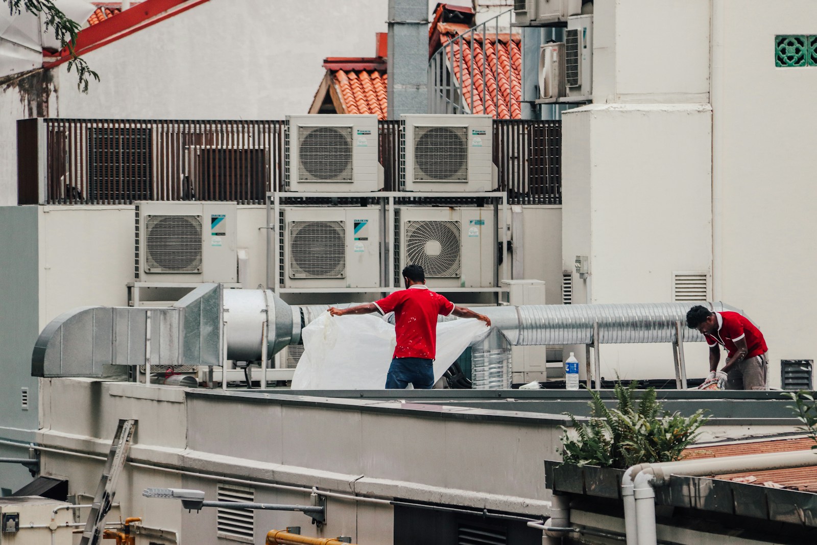 Crew installing rooftop HVAC equipment on a commercial building