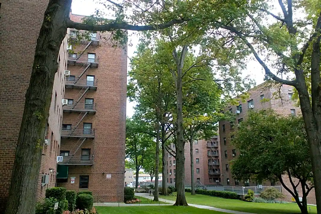 Level 2 EV charging stations at Hilltop Village in Queens, NY, showing the extensive charging infrastructure installed across the residential community parking area